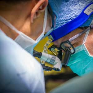 Close-up of two medical professionals in masks and special glasses