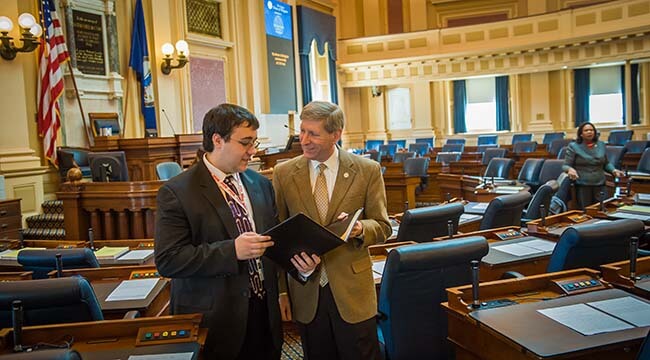 Two men talking in general assembly room of Virginia State Capitol