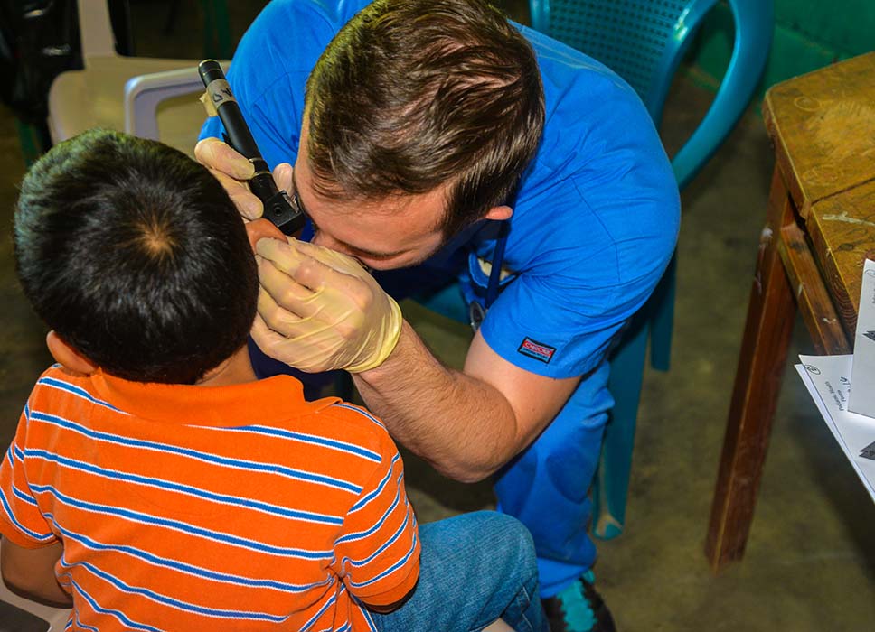 Medical professional examining childVCU’s ear