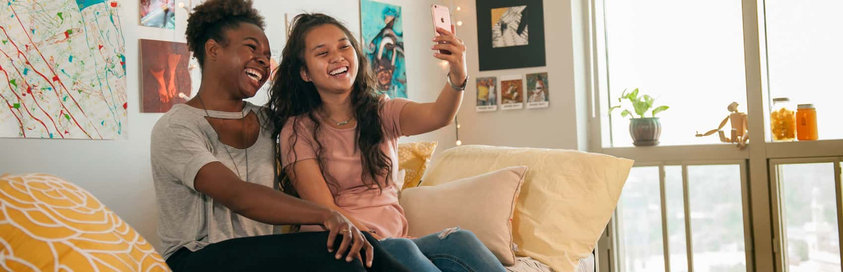 Two female students taking a selfie in their dorm room