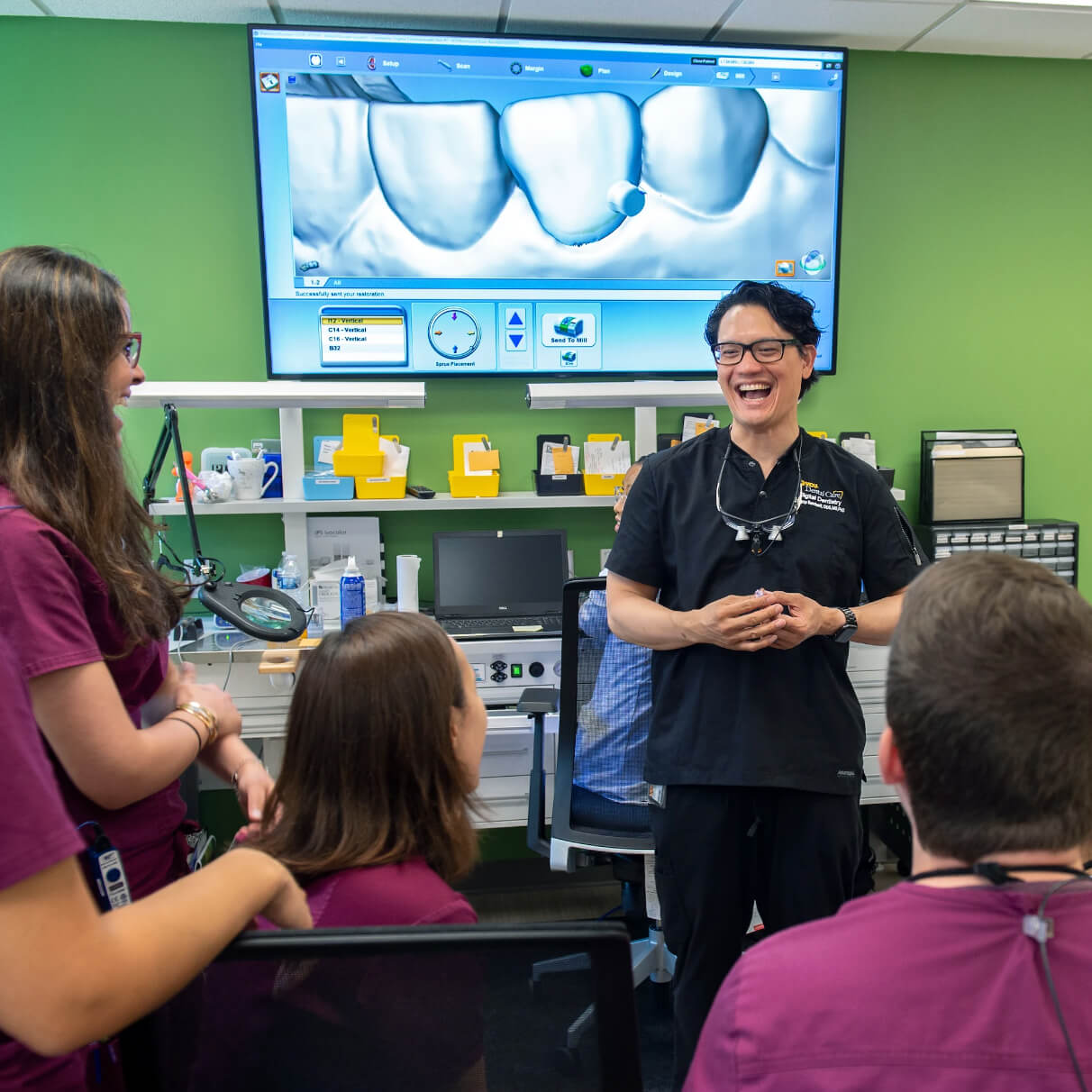 A dentistry professor teaching students.